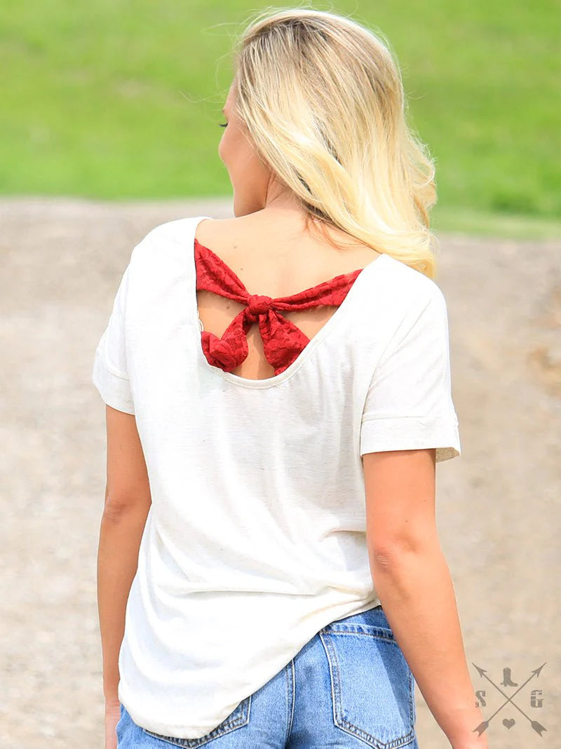 NASHVILLE BOOT ON HEATHERED BEIGE TEE WITH BOW BACK DETAIL